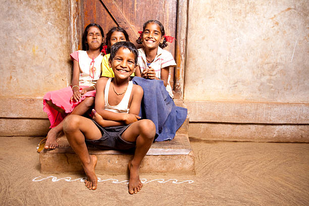 Group of four Cheerful Rural Indian Children Group of Cheerful Rural Indian Children in a village in Maharashtra indian boy barefoot stock pictures, royalty-free photos & images