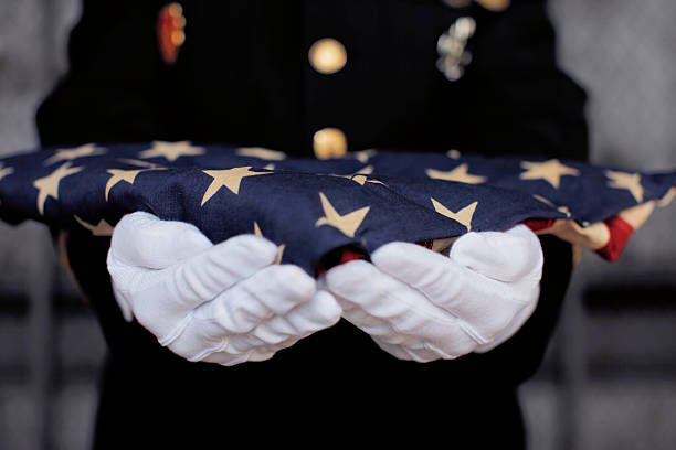 Ceremonial Flag offering Military personnel holding a folded US flag. formal glove stock pictures, royalty-free photos & images