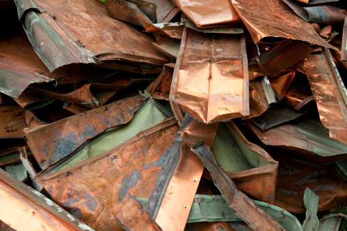 Old copper roofing piled up for recycling.