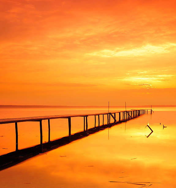 Tranquil Lake with Boardwalk Dock at Sunrise