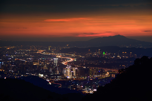 Heavy traffic in the city, time-lapse photography of car lights. View of the urban landscape from Dajianshan Mountain, New Taipei City.