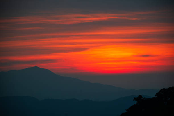At dusk, orange sky and black clouds. Abstract background. View of the urban landscape from Dajianshan Mountain, New Taipei City.
