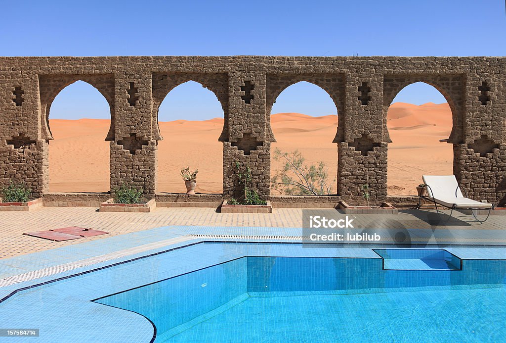 Beautiful arches by swimming pool in Sahara desert, Morocco Beautiful arches by swimming pool in Sahara desert, Erg Chebbi Dunes, Morocco. XXXL Canon 5D Mark II. Similar:     Morocco Stock Photo
