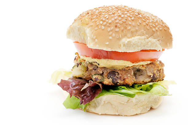American style bean burgers with vegan cheese, tomato, onion, chips and green vegetable salad.