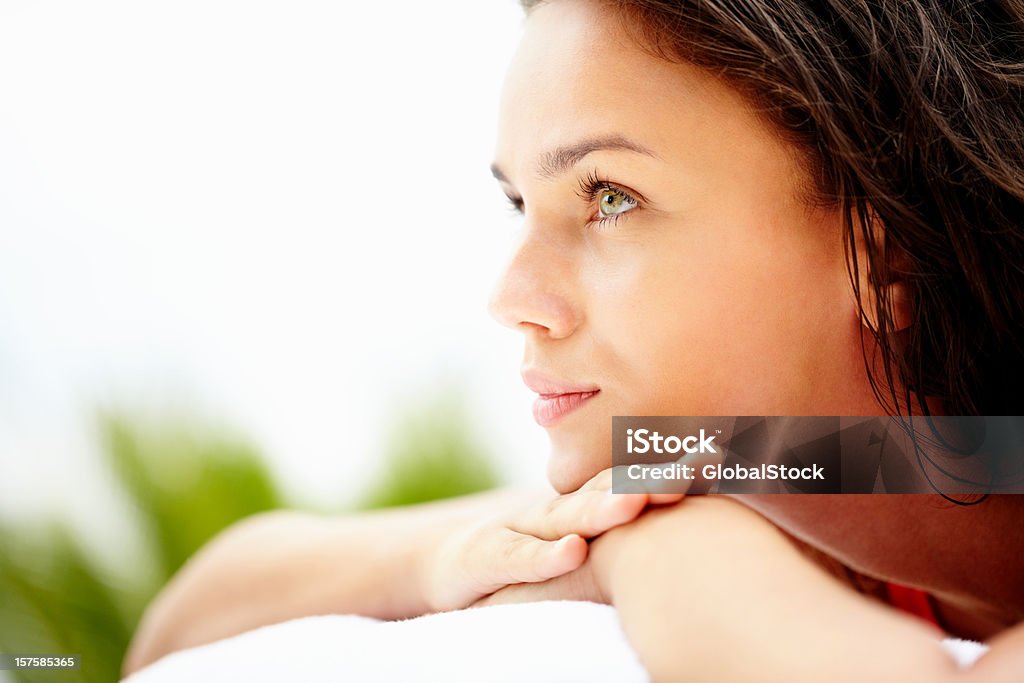 Closeup of a young female resting outdoors Closeup of a pretty young woman resting outdoors Side View Stock Photo