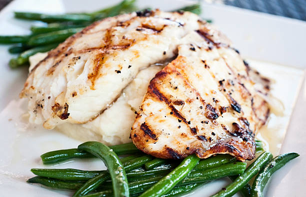 Grilled fillet of fish char grilled fillet of fish over mashed potatoes and green beans close up char grilled photos stock pictures, royalty-free photos & images