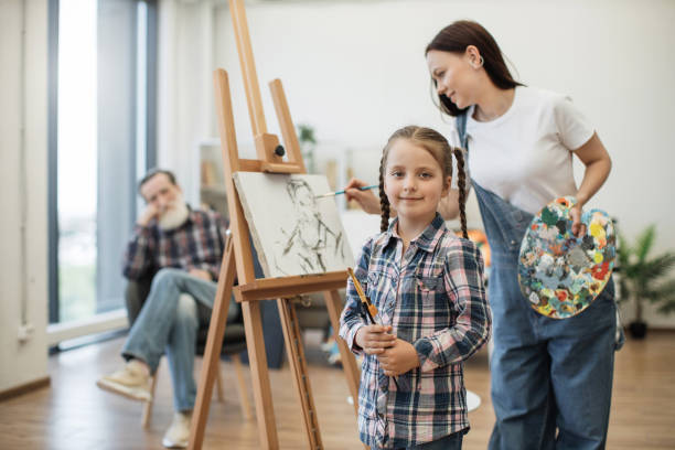 istock Child with brushes taking part in creativity at home studio 1575854603