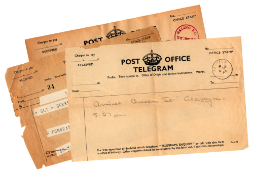 Three old British telegrams, with the top one dated 1940 and announcing the arrival of the sender at Queen Street Railway Station, Glasgow.