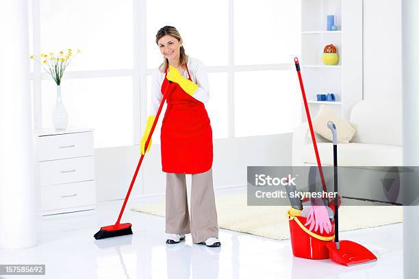 Charwoman Sweeping A Room Stock Photo - Download Image Now - Adult, Adults Only, Apron