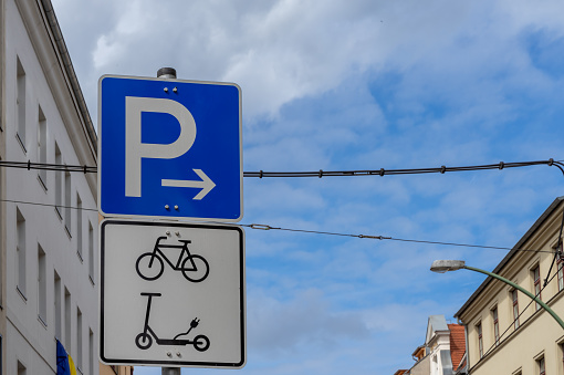 Low angle view of parking sign for bicycle and scooter , Central Berlin