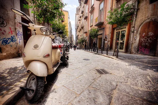 Photo of Line of Vespas on an Italian street in the summer