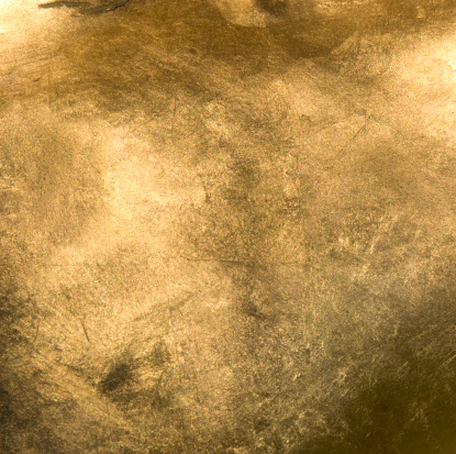 Full frame Gold background. The gold in the image is shiny and has a lot of texture and colors.