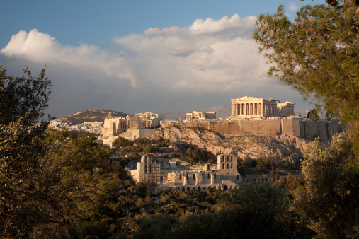 View from the top of Philopappos Hill of the ancient Parthenon, Odeon of Herodes Atticus Theatre and the propylaea gateway on Acropolis Hill at the Greek city of Athens Greece.