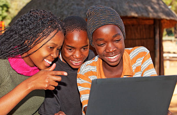 African children looking at Laptop