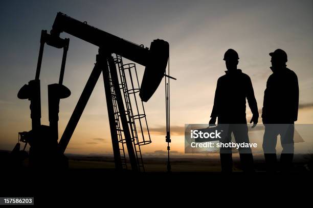 Two Workers And An Oil Derrick Stock Photo - Download Image Now - Repairing, Oil Field, Geology