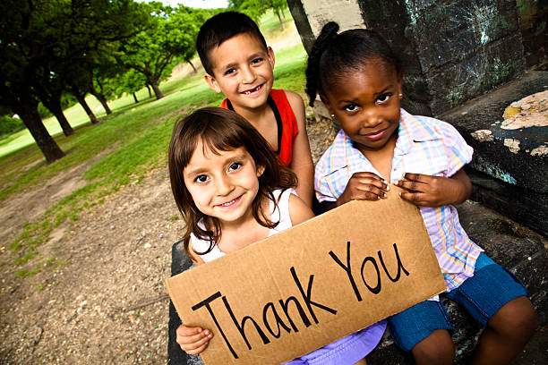 Three Cute Kids Smiling and Holding a Thank You Sign Three Cute Kids Smiling and Holding a Thank You Sign. thank you phrase stock pictures, royalty-free photos & images