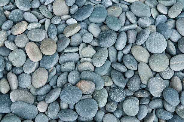 Close up of rounded grey river rocks stock photo