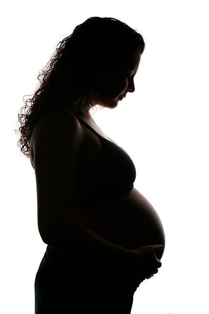 Pregnant Woman Silhouette  8 months pregnant stock pictures, royalty-free photos & images
