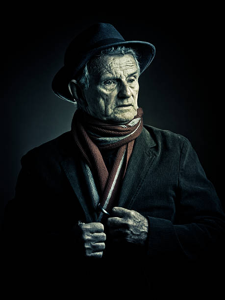 old man surprised senior man kind of lost in thoughts and surprised for a moment - wearing a fedora hat and a red scarf mafia boss stock pictures, royalty-free photos & images