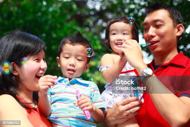 Young Family Playing Bubble In The Garden Stock Photo - Download Image Now - 30-39 Years, Adult, Asian and Indian Ethnicities