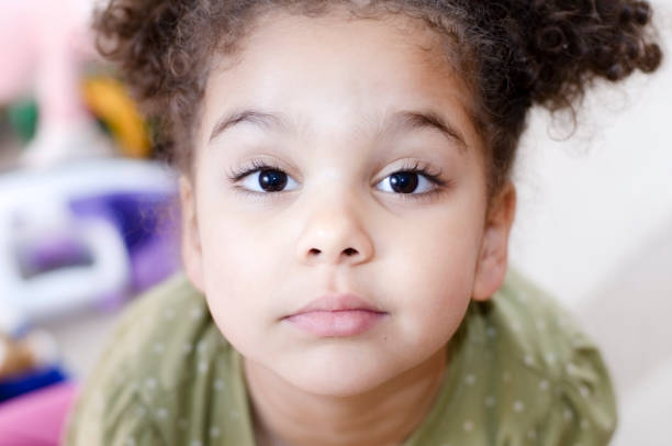 istock Little girl looking up at camera 157586745
