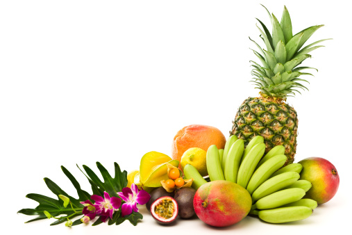 Summer fruits background. Various tropical fruits on turquoise  background - mango, coconut, apples, avocado, lemon, orange, grapefruit, pineapple, with palm leaves. Colorful frame, banner flatlay