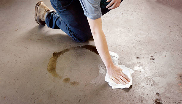 Oil clean-up in a garage or workshop stock photo