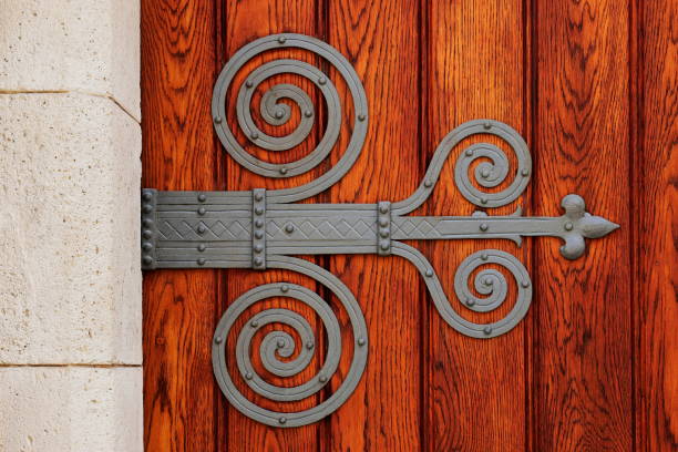 An ornate wrought iron hinge on an old church door