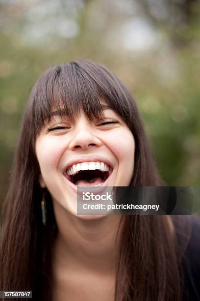 Dark Haired Woman With Bangs Is Laughing Stock Photo - Download Image Now - Adult, Close-up, Human Lips