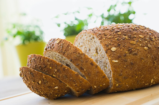 Sliced whole wheat bread on chopping board