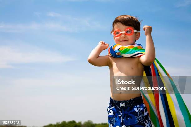 Cute Boy With Swimwear On Flexing Muscles Stock Photo - Download Image Now - Child, Swimming Goggles, Scuba Mask