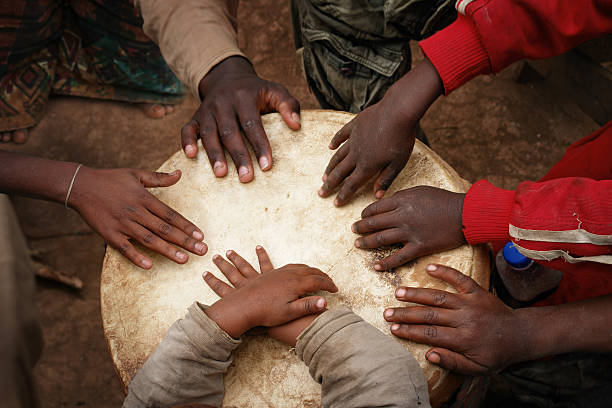 las manos de niños africanos tocando el tambor grande - drum musical band indigenous culture human finger fotografías e imágenes de stock