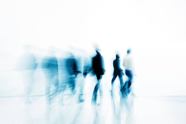 abstract siluetas de personas de negocios a contra fondo blanco - blurred motion motion group of people crowded fotografías e imágenes de stock