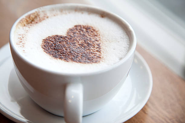 Cup of cappuccino with a heart design stock photo