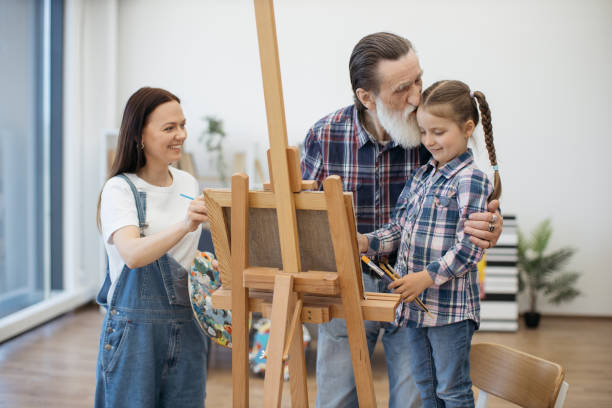 istock Grown-ups and child engaging in arts at home workshop 1575889064