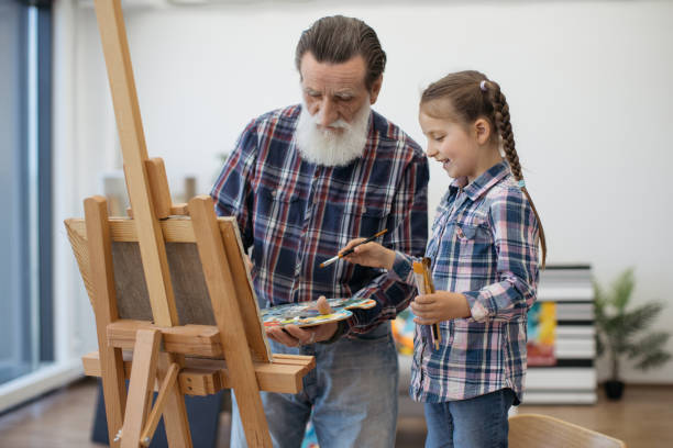 istock Grandpa teaching color combination rules to child in studio 1575889091