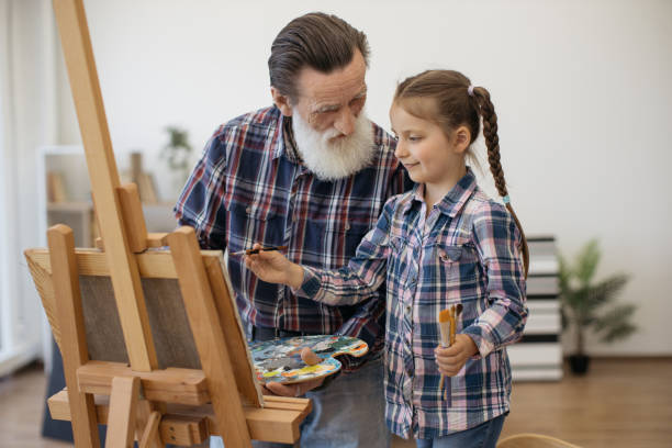 istock Grandpa teaching color combination rules to child in studio 1575889106