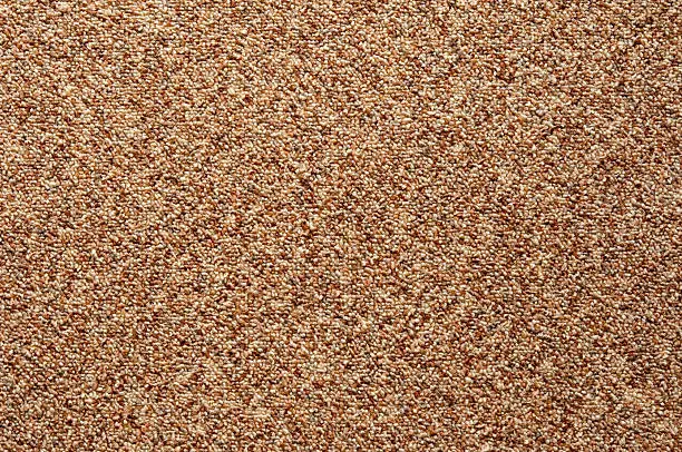 Photo of Wall-to-wall carpet loop fabric speckled brown pattern full frame