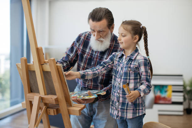 istock Grandpa teaching color combination rules to child in studio 1575889634