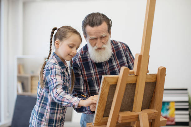 Grandpa teaching color combination rules to child in studio