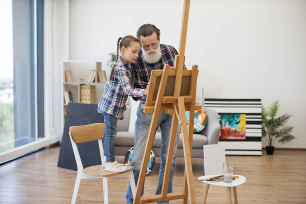 istock Grandpa teaching color combination rules to child in studio 1575889664