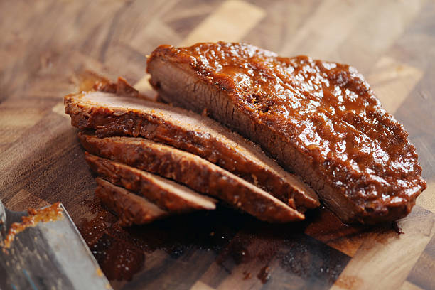 Closed up of sliced brisket on wooden cutting board stock photo