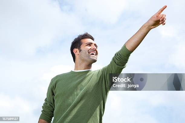 Foto de Homem Sorridente Apontando Para O Céu Aberto e mais fotos de stock de Apontar - Sinal Manual - Apontar - Sinal Manual, Homens, Direcionar