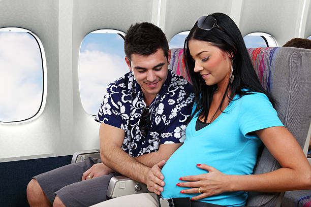Pregnant Woman On Airplane  gchutka stock pictures, royalty-free photos & images