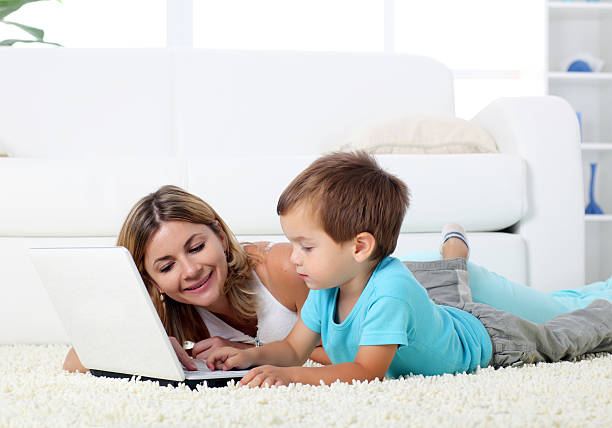istock Mother and her cute son typing on notebook. 157589353