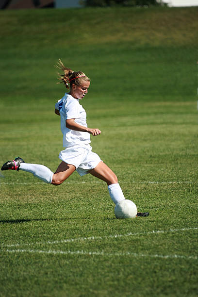 istock Attractive Female Soccer Player in Profile Kick with copyspace 157589422