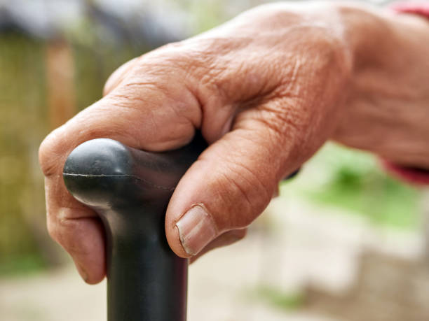 istock Elderly woman holding a stick while moving. 1575895179