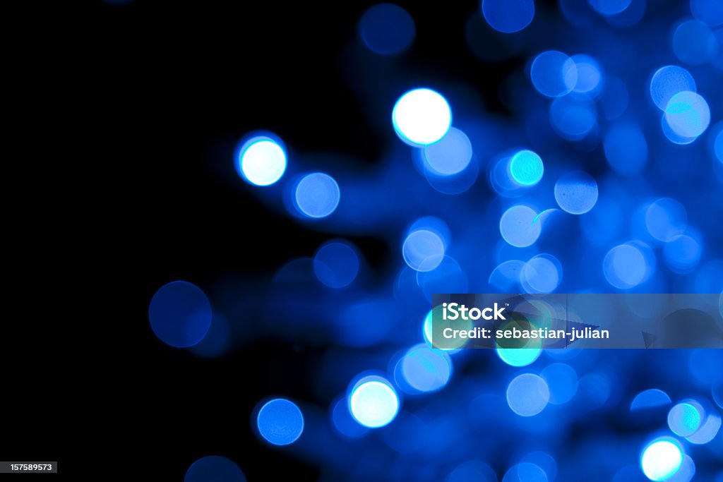Out of focus illuminated blue dots on black background XXXL - defocused blue light dots with light spots - nice holyday background - camera canon 5D mark II - unsharped RAW - adobe colorspace Blue Stock Photo