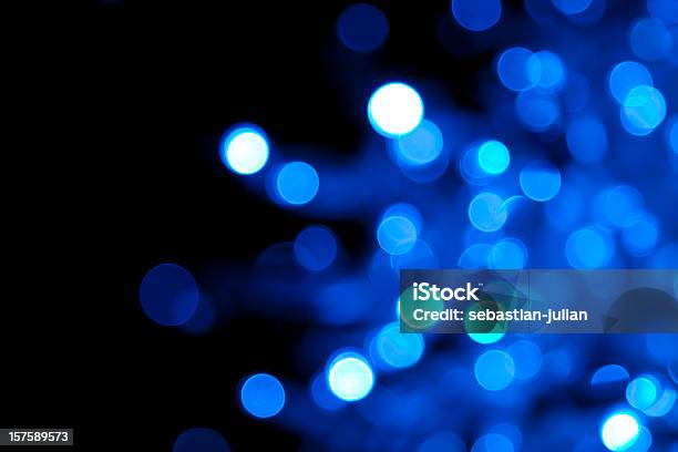 Out Of Focus Illuminated Blue Dots On Black Background Stock Photo - Download Image Now