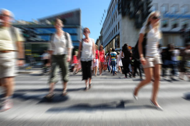 istock Young people crossing sunlit street, motion blur 157589674